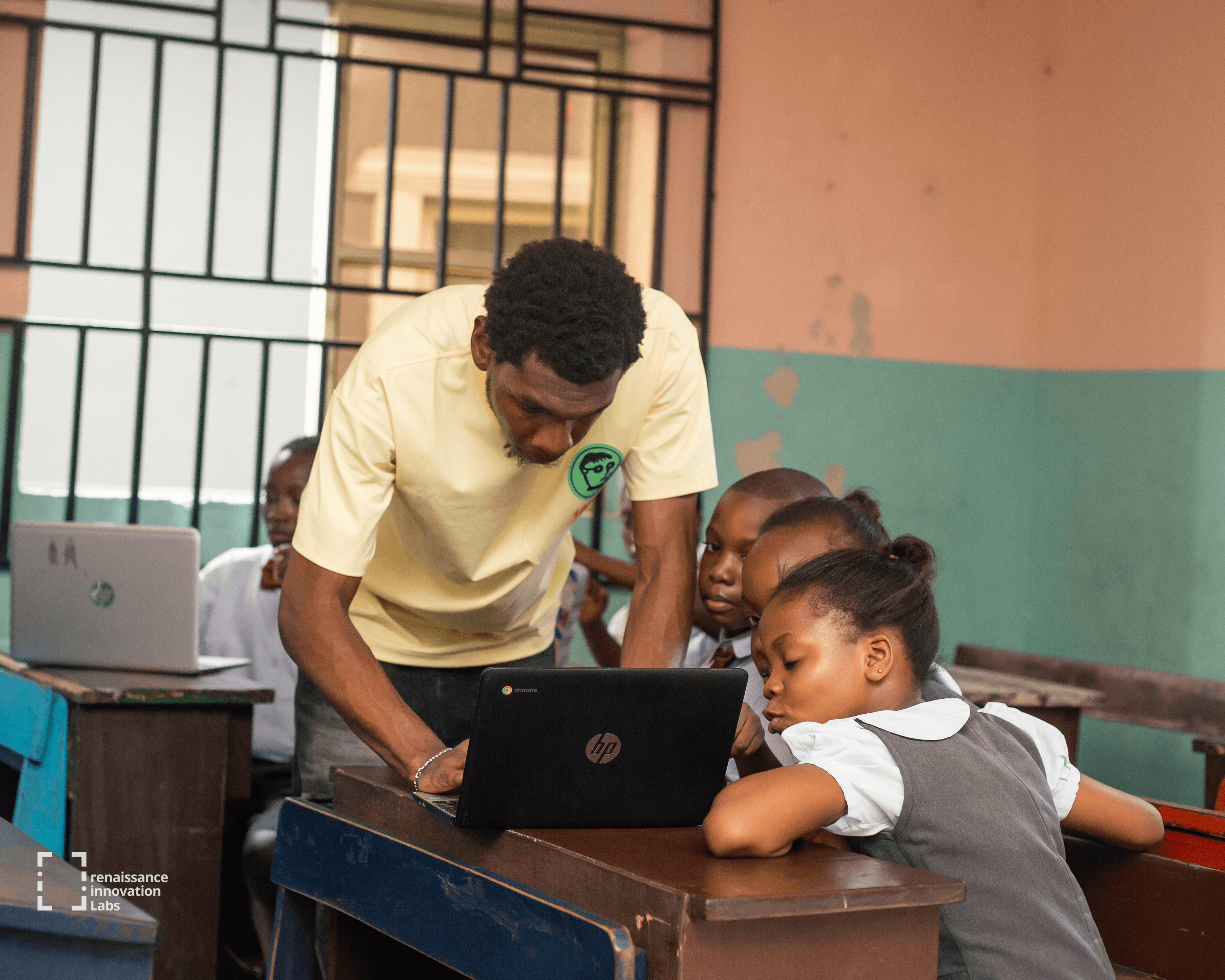 Mentor guiding a camper through a project at the RIL lab