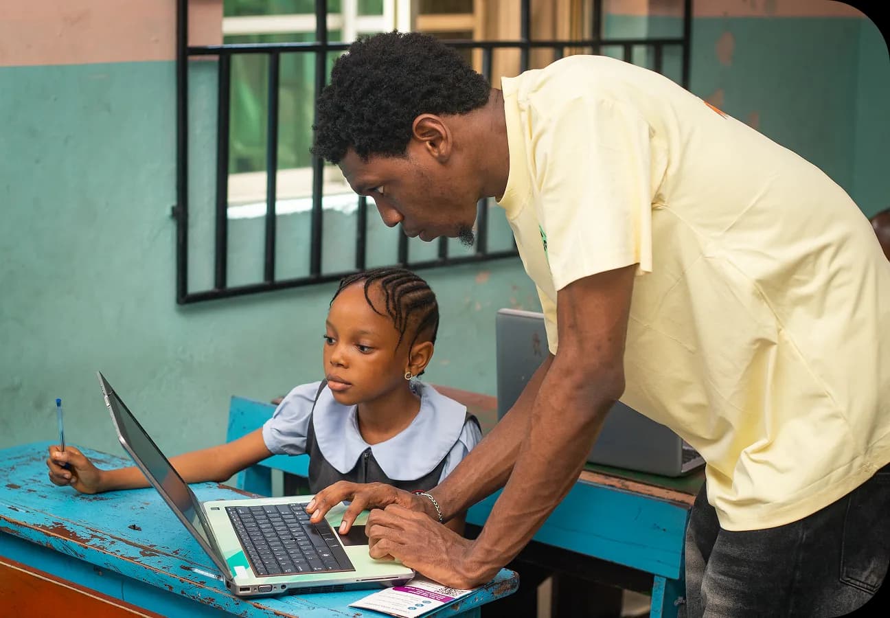 Kids coding on laptops